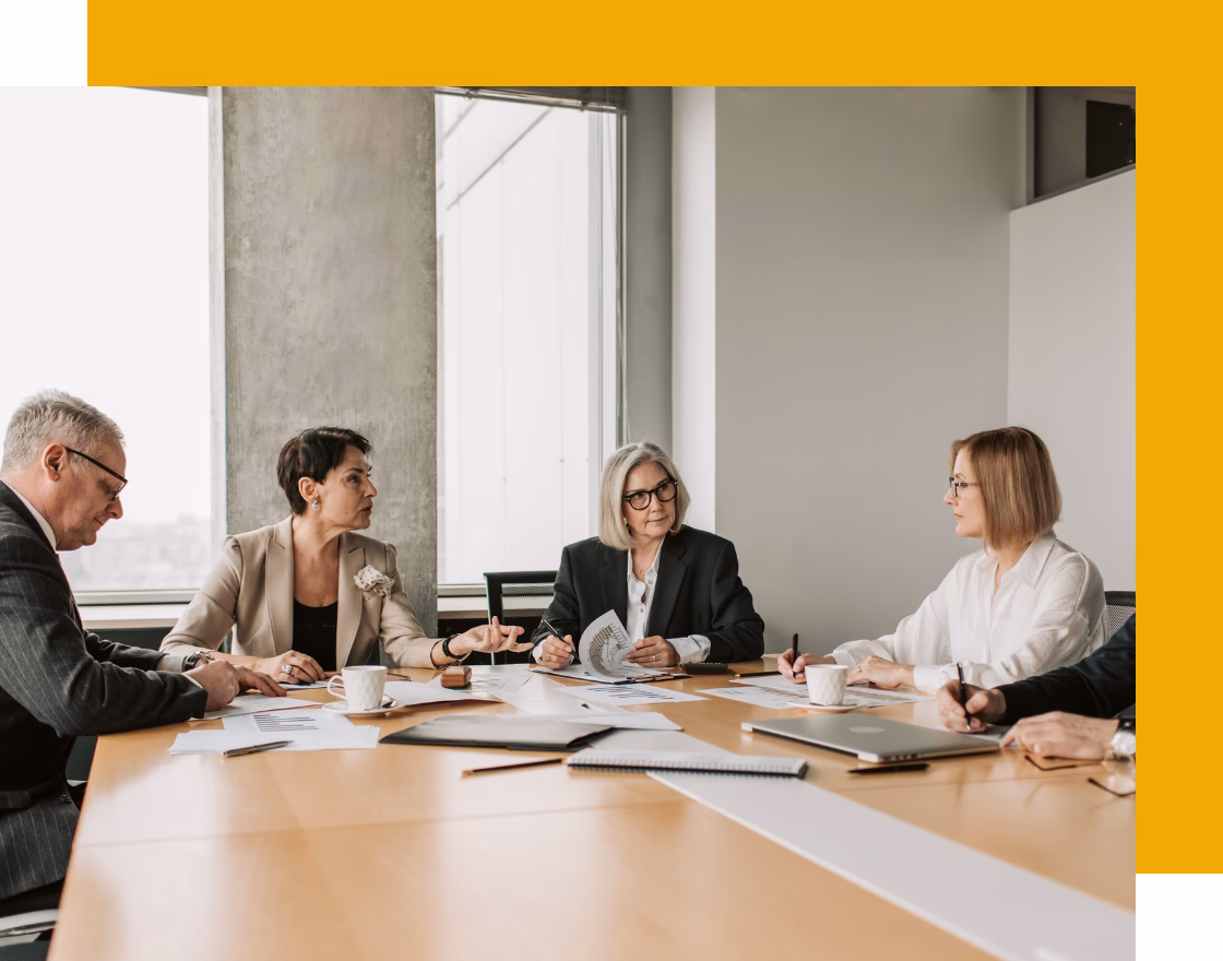 Image of multiple people in professional business attire discussing important topics for Montgomery County ADAMHS Board which helps public mental health and addiction planning for people in Montgomery County, Ohio.